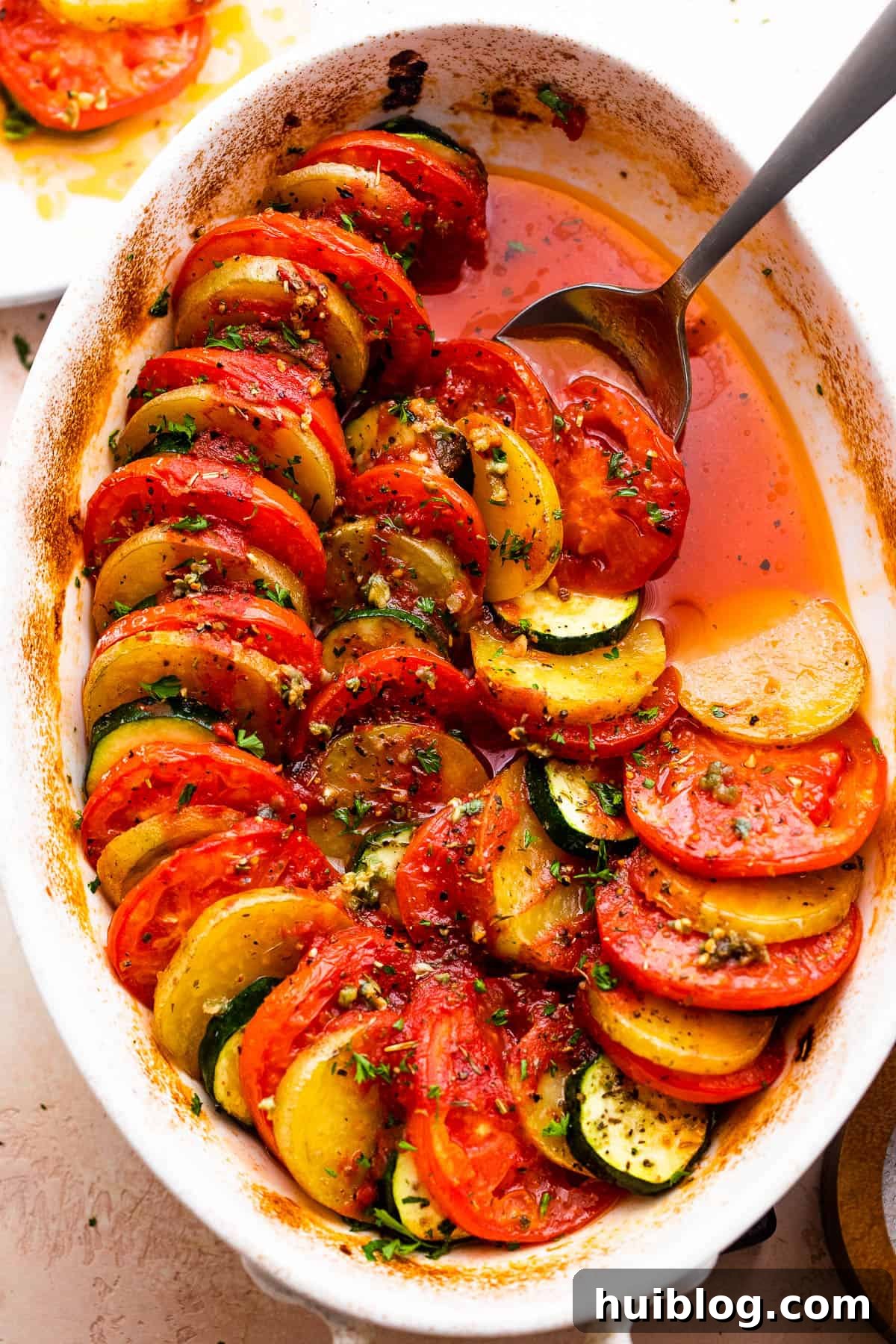 Sun-Kissed Zucchini Tomato Bake 6 Overhead perspective of the complete Zucchini Tomato Potato Gratin, garnished and ready to be served, highlighting its rich textures and appetizing golden-brown finish.