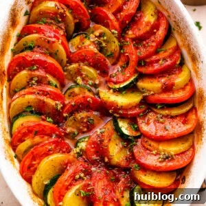 Sun-Kissed Zucchini Tomato Bake 7 Overhead shot of zucchini, tomato, and potato slices arranged accordion style in a baking dish.