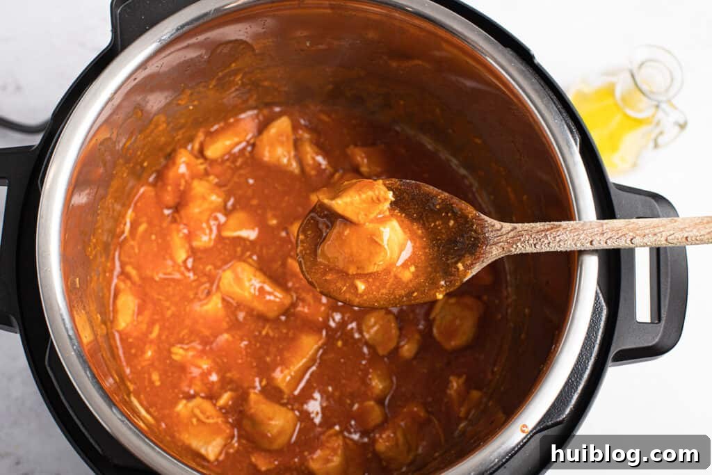 Thickened and glazed Instant Pot orange chicken, ready to be served.