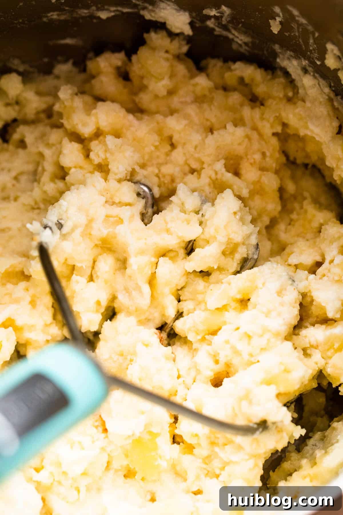 mashing potatoes with a potato masher