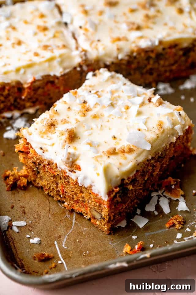 The Best Carrot Cake Recipe: A Moist, Spiced Delight with Homemade Cream Cheese Frosting A delectable square slice of moist carrot cake topped with thick cream cheese frosting and a sprinkle of walnuts.