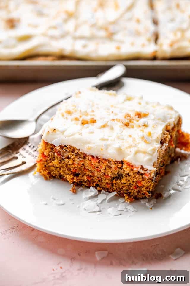 A perfect slice of homemade carrot cake. A pristine slice of carrot cake, perfectly frosted and ready to be savored, presented on a simple white plate with a fork.