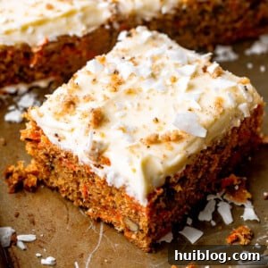 Delicious slice of carrot cake with cream cheese frosting. A square slice of the best carrot cake, beautifully frosted with thick cream cheese icing and a light sprinkling of walnuts.