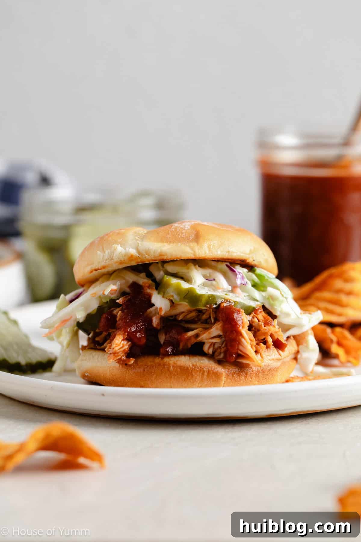 Effortless Slow Cooker BBQ Pulled Chicken 11 BBQ Chicken sandwich with pickles and coleslaw.