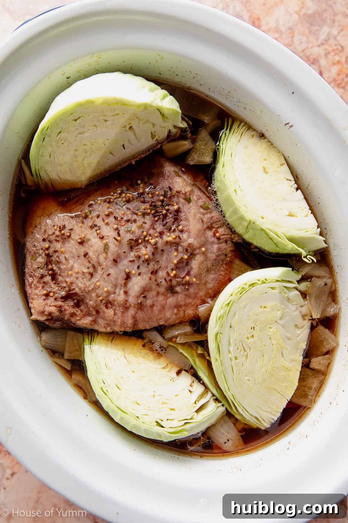 Cabbage added to a corned beef cooking in a slow cooker. 