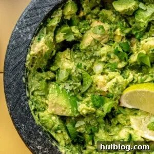 Up close image of guacamole in a molcajete.