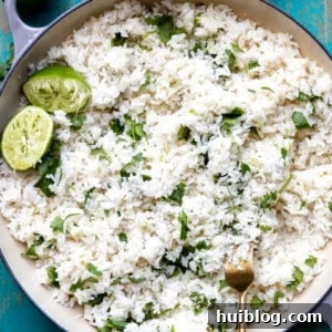 Cast iron pot filled with cooked white cilantro lime rice.
