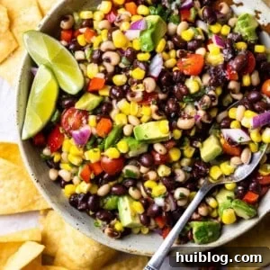 Bowl of Texas Caviar black eyed pea dip served with lime garnish.
