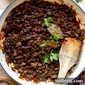 White braising skillet filled with carne picada,