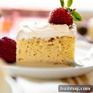 Homemade tres leches, three milk cake, topped with fresh strawberries.